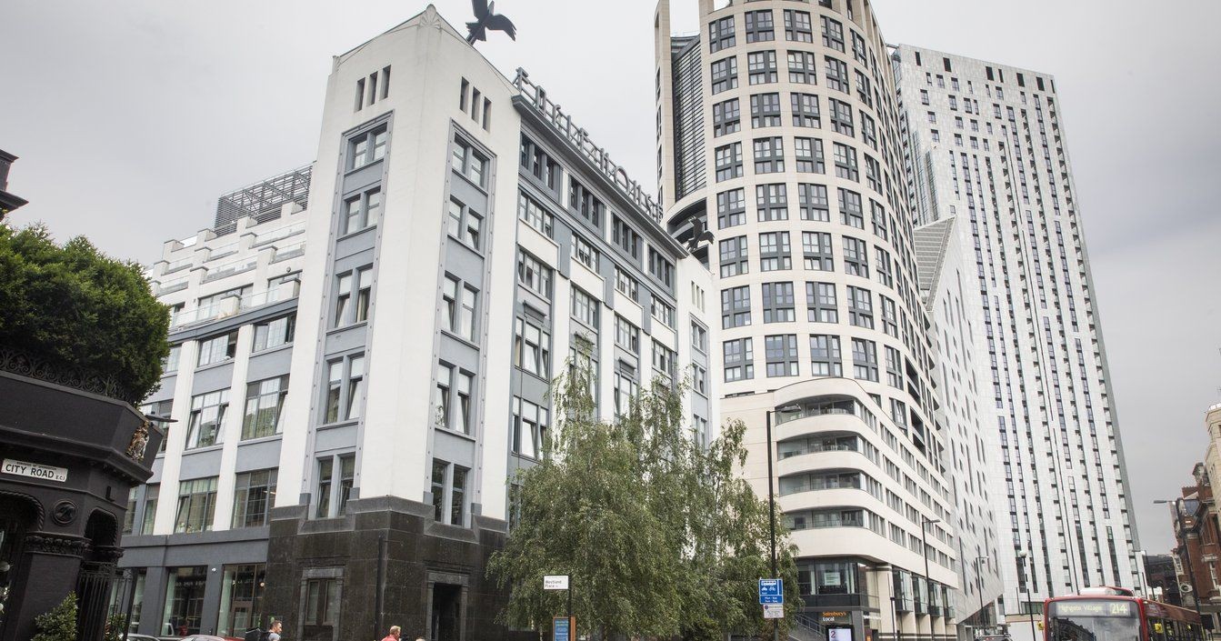 Street view of modern office buildings with large windows and varying architectural styles, located on City Road.